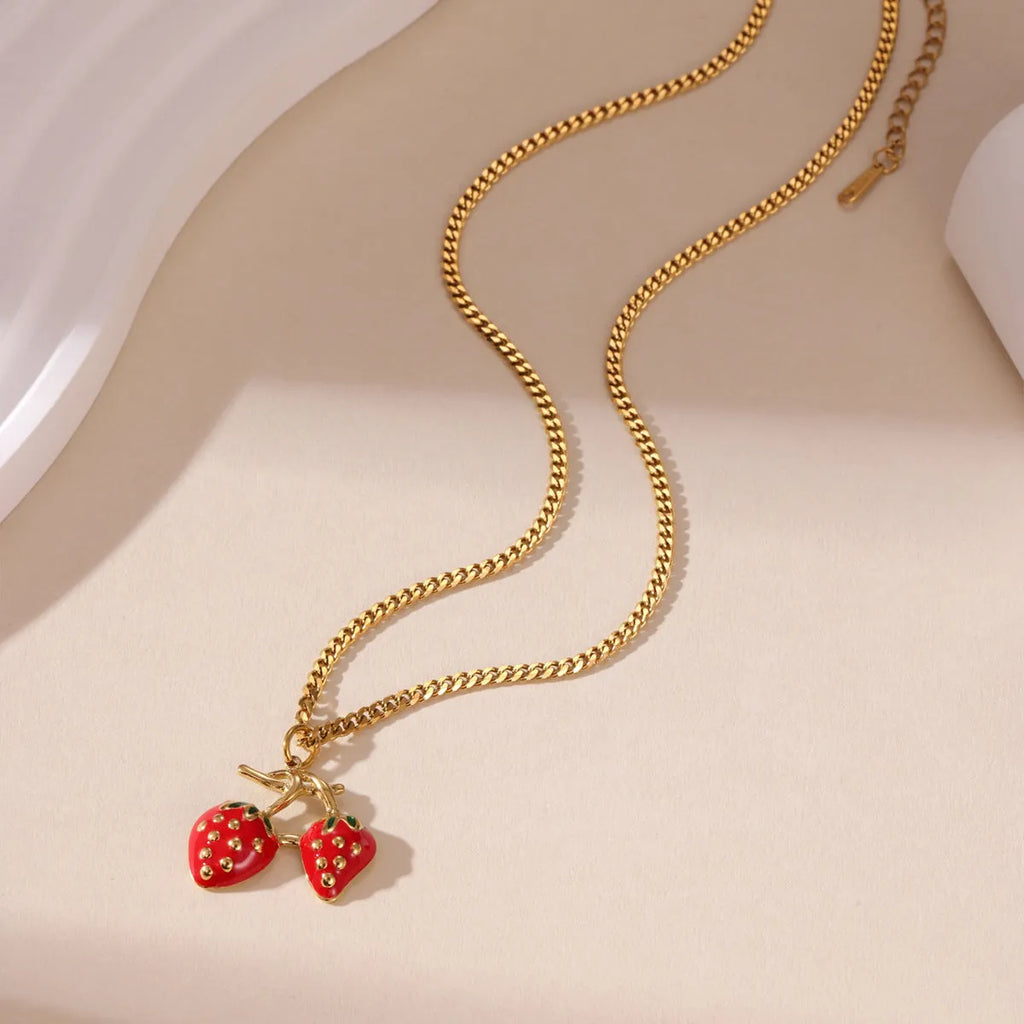 Women's strawberry-shaped alloy pendant necklace on a stainless steel chain in red or white powder gradient colour.