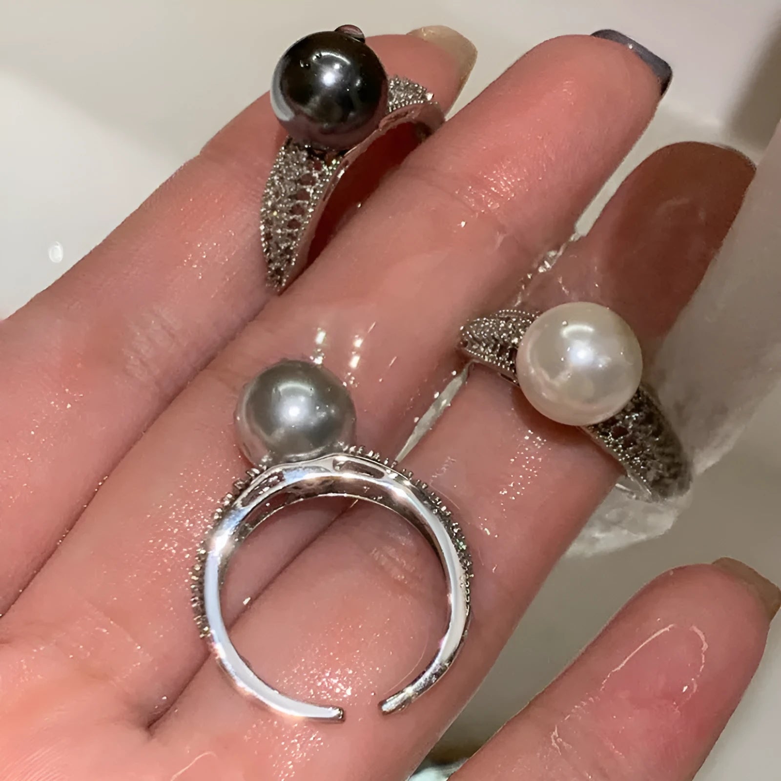 Open finger ring with geometric design, black pearl accent, and adjustable copper band