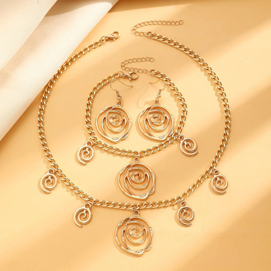 Spiral donut jewellery set showing necklace, bracelet, and earrings in geometric circle design with gold finish