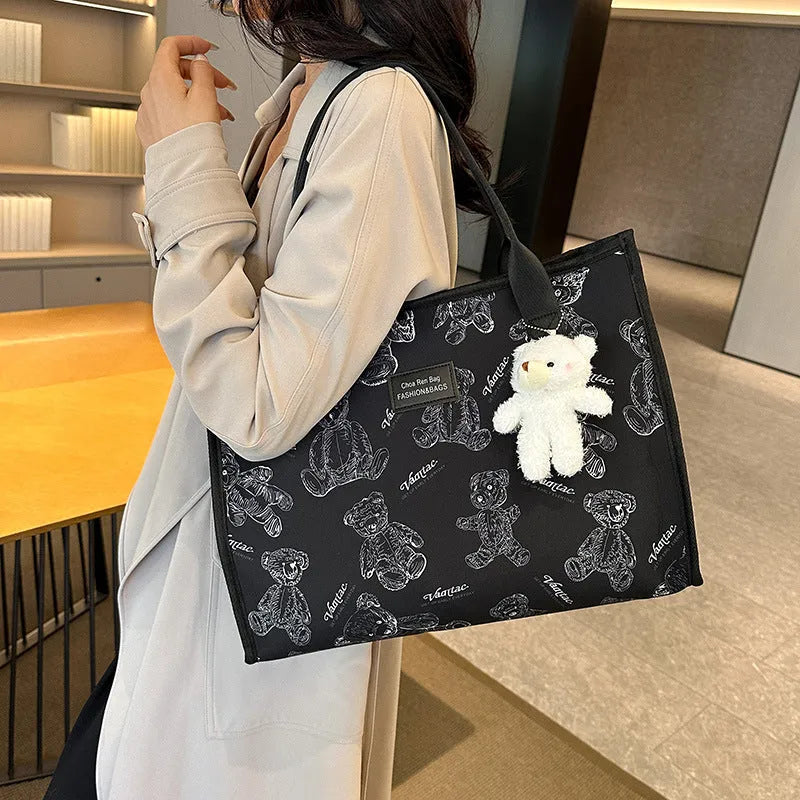 Women's black and white rhombus pattern canvas tote bag with shoulder strap showing horizontal square shape
