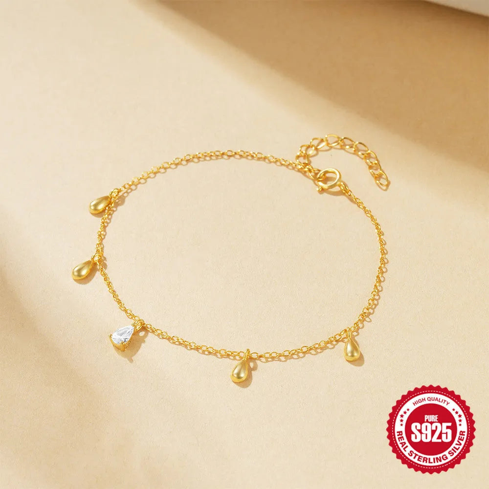 Gold S925 sterling silver bracelet with water drop diamond pendant on a geometric chain.