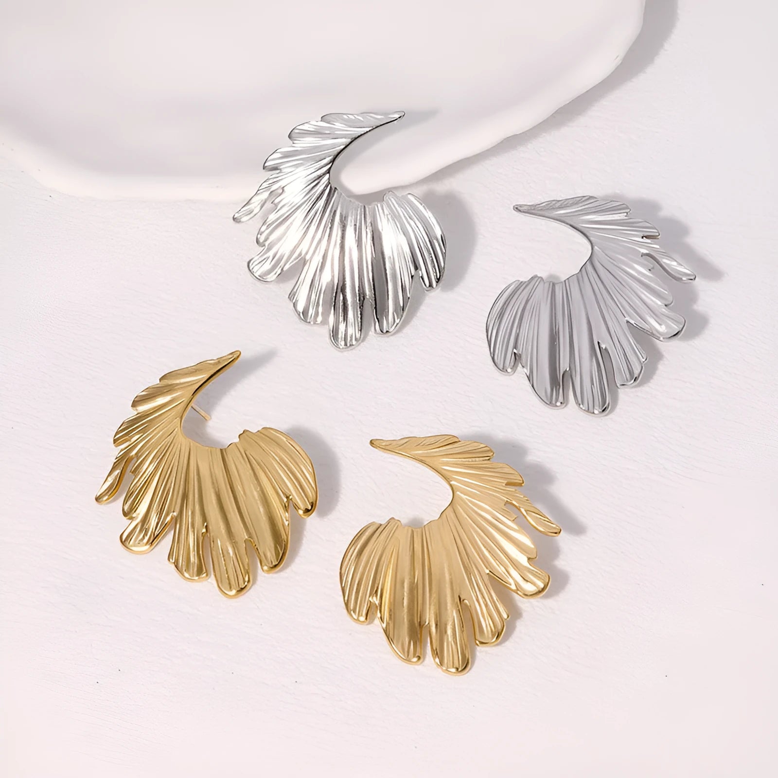 Stainless steel leaf-shaped stud earrings in gold and steel colour options