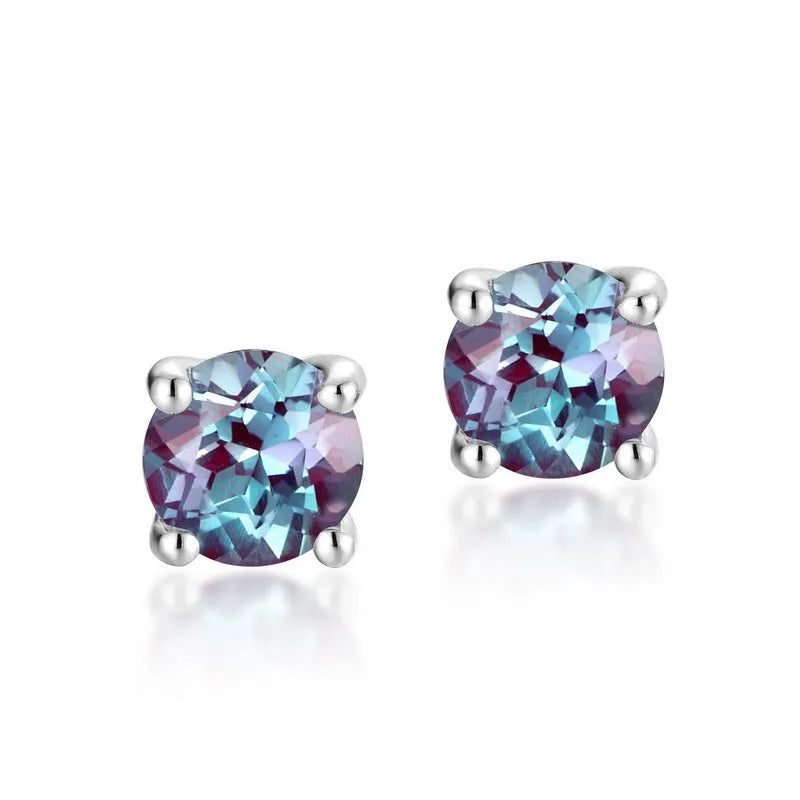 A pair of sterling silver geometric circle ear studs with a cultivated alexandrite stone.