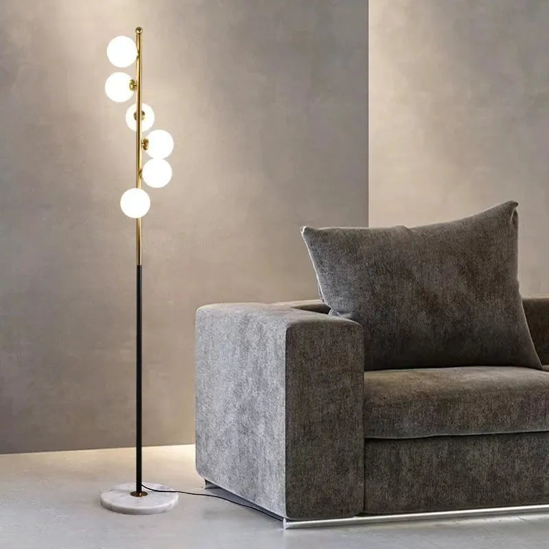 Tall minimalist Nordic style floor lamp with iron frame and glass shade on a stable iron base.