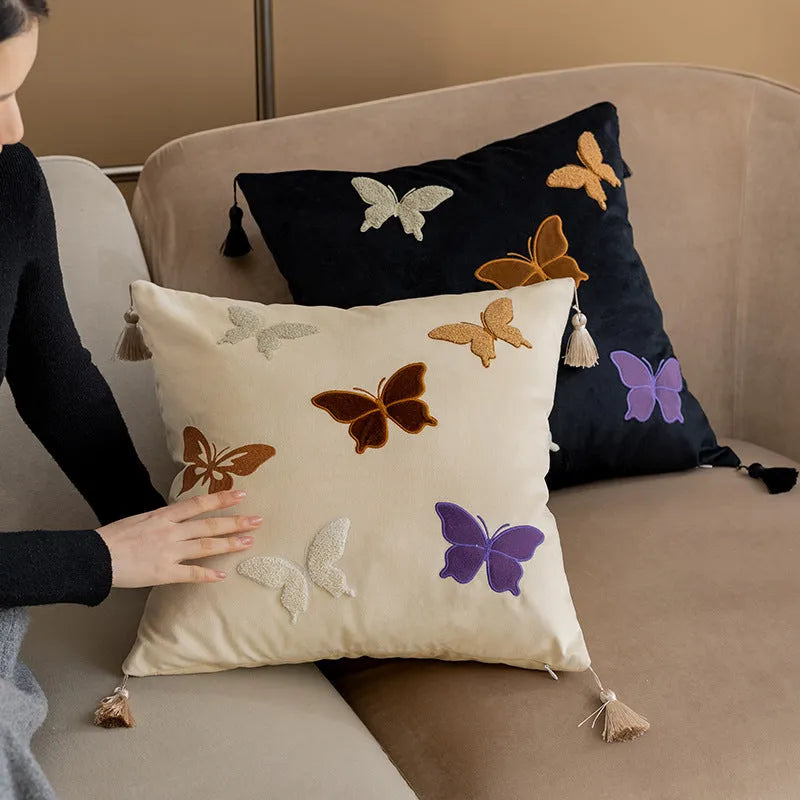 Square beige cushion with detailed black butterfly embroidery in a Chinese style.