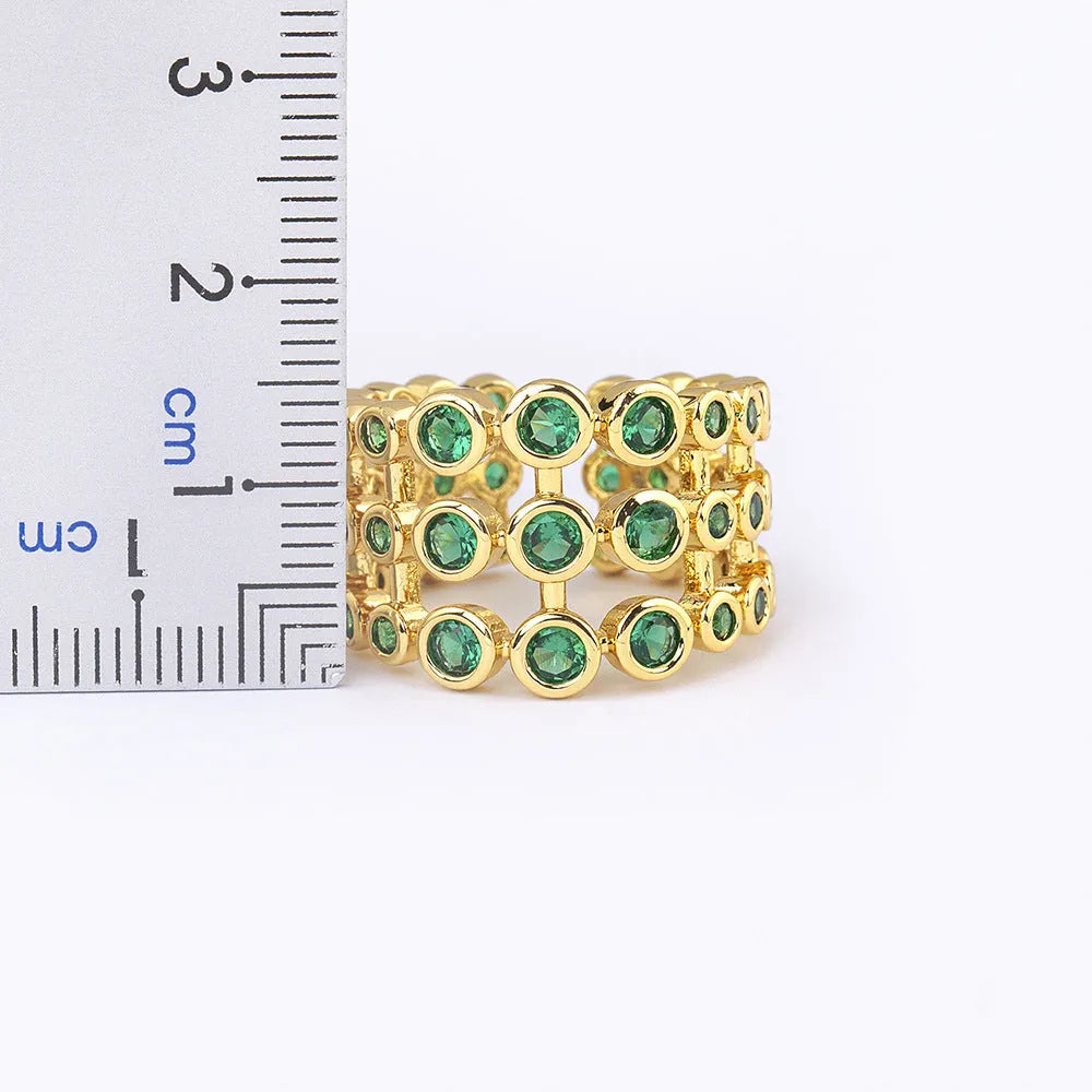 Three-layer wide band statement ring with green zircon stones and gold plating on copper base