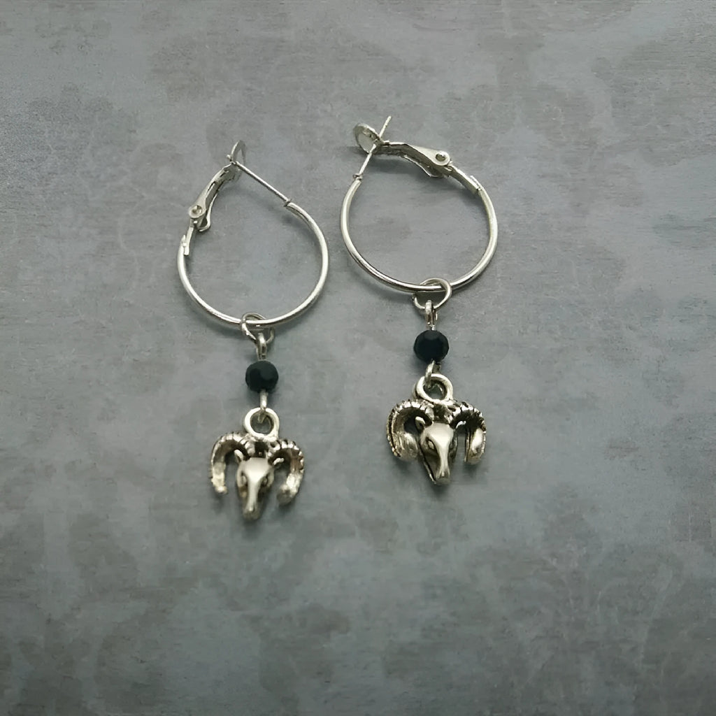 Silver alloy round hoop earrings with a detailed Tibetan antelope silhouette design.