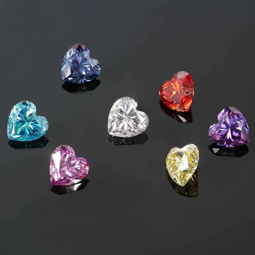 Colourful heart-shaped moissanite gemstones in red, blue, yellow, and pink for jewellery making.