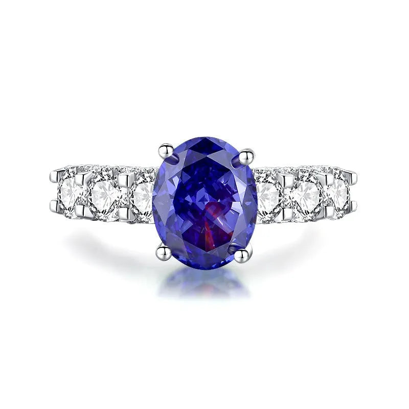 Close-up of a women's heart-shaped sterling silver ring with a faceted ice flower cut zircon gemstone.