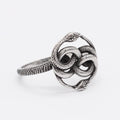 Titanium steel double snake ring in steel colour on a plain background, showing retro design detail.