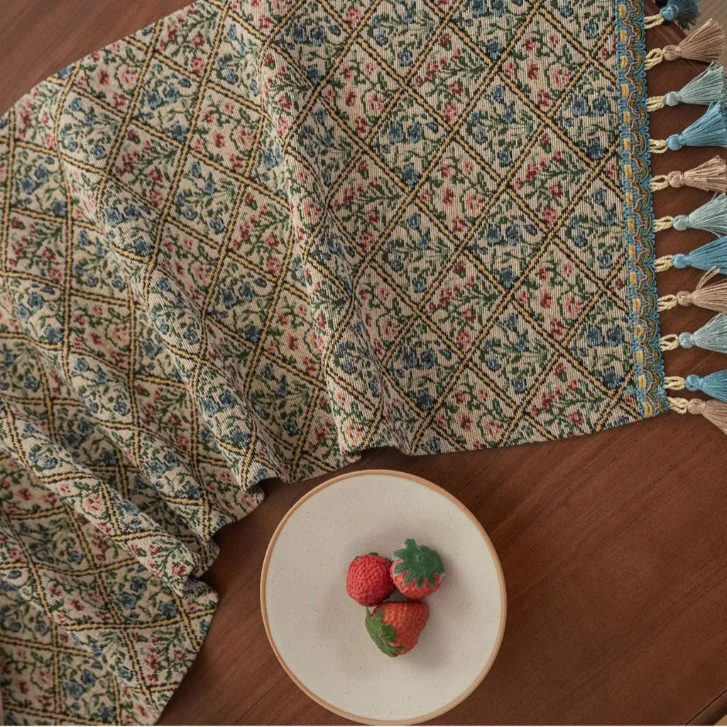 Nordic jacquard table runner with tassel fringe in dark blue with striped pattern on wooden table