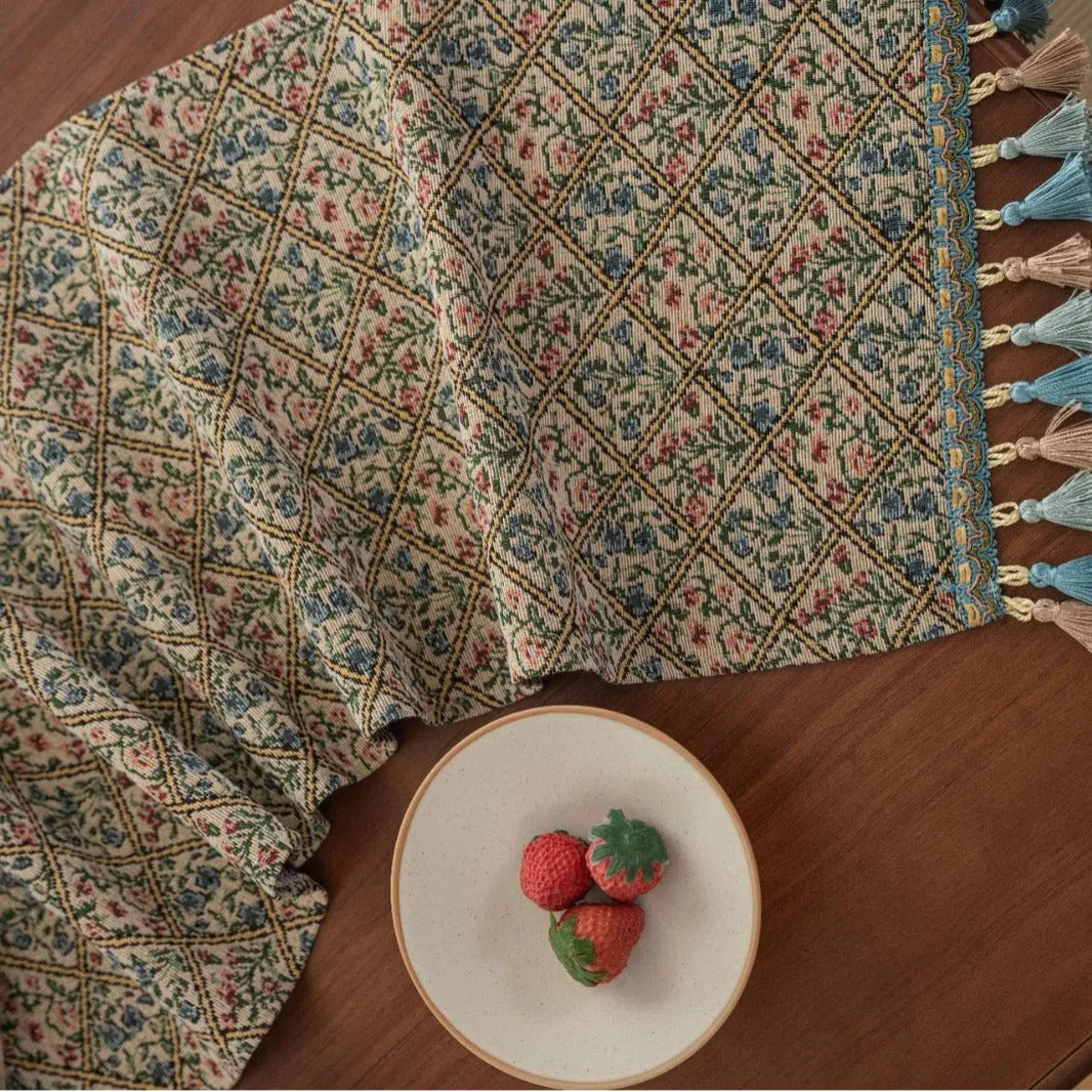Nordic jacquard table runner with tassel fringe in dark blue with striped pattern on wooden table