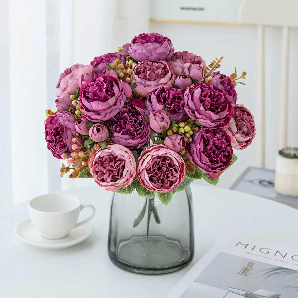 Silk artificial peony bouquet in champagne colour on a table for home or wedding decor.