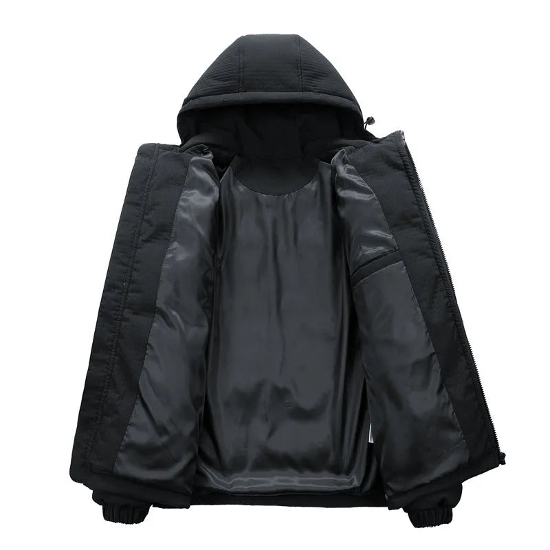 A man wearing a black hooded cotton-padded winter coat with letter-print detail and side pockets.