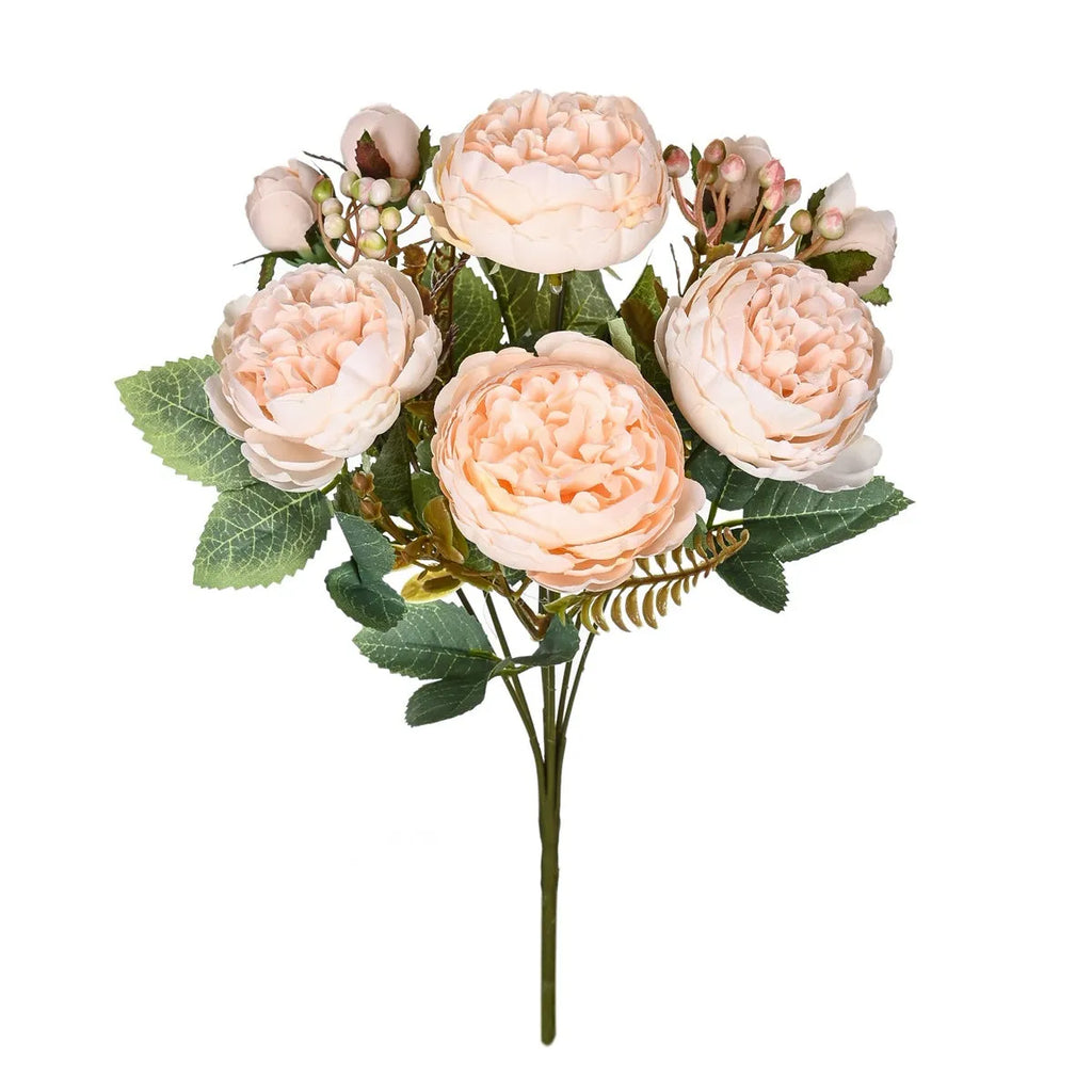 Silk artificial peony bouquet in champagne colour on a table for home or wedding decor.