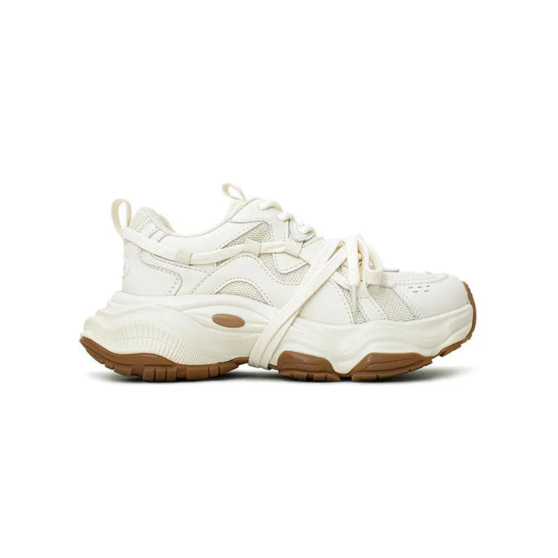 Beige women's casual sneakers with a platform heel and round toe, showing lace-up front.