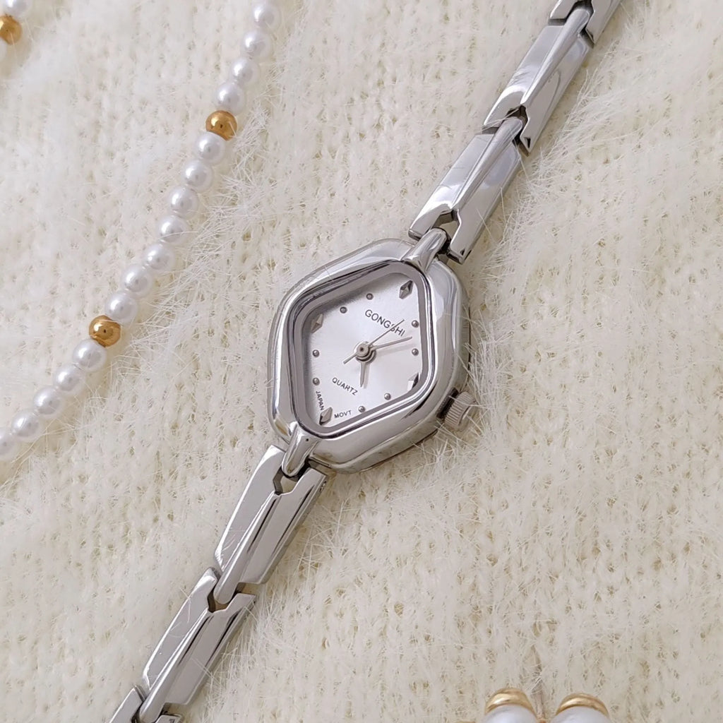 Ladies diamond fashion watch with gold or silver finish and chain strap, showing 7mm thickness and mineral glass face