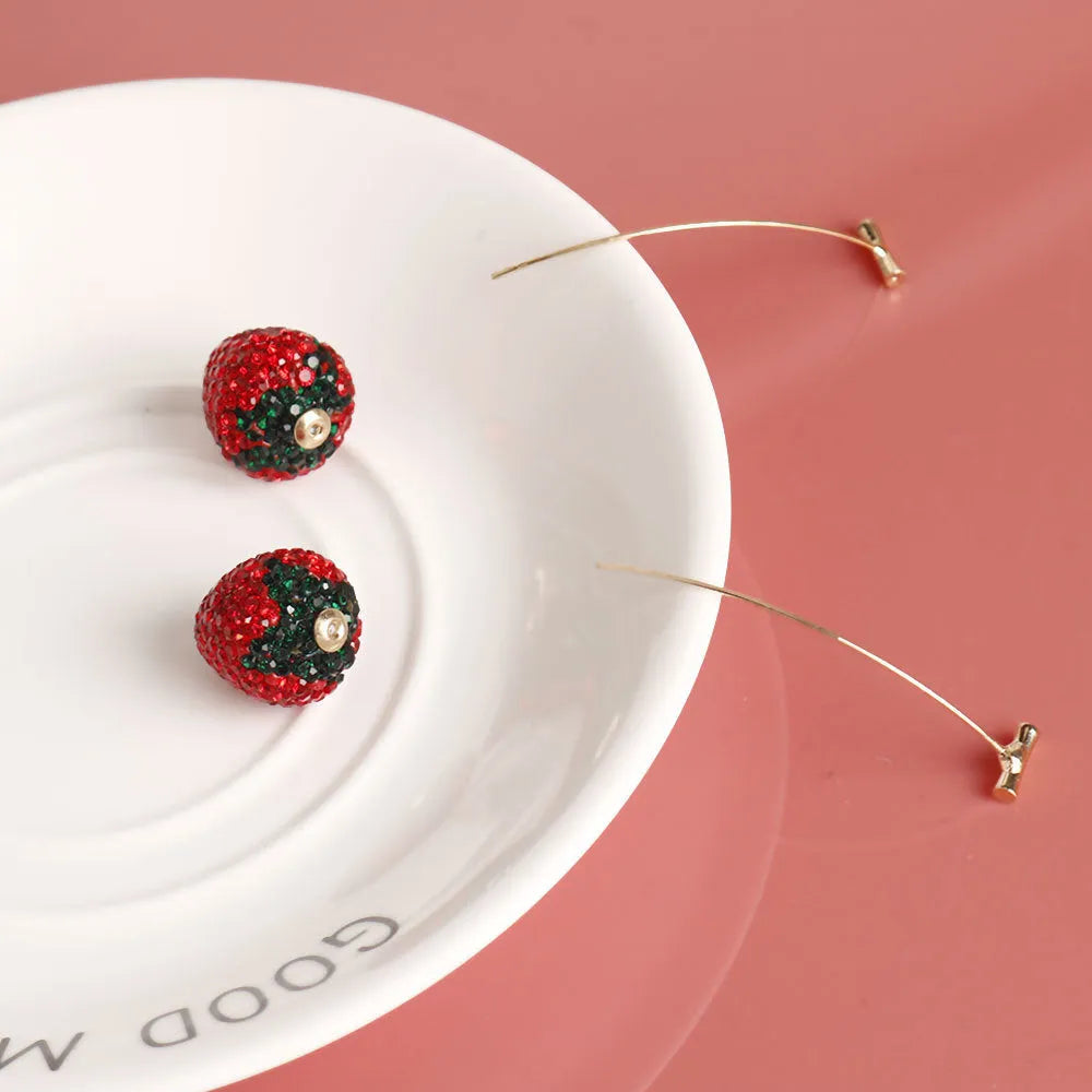 Red geometric strawberry-shaped dangle earrings with spot drill texture on zinc alloy.