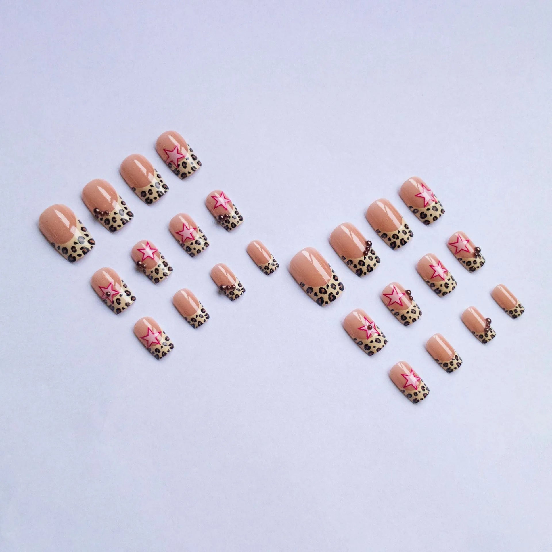 French leopard print nail art with five-pointed stars, pearl and diamond accents on wearable nail pieces