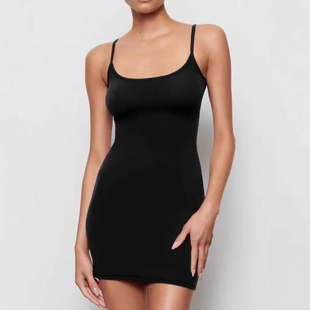 Black sleeveless sling dress with a mid waist and short skirt sheath silhouette.