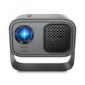 Black compact HD smart portable projector with remote control on a table.