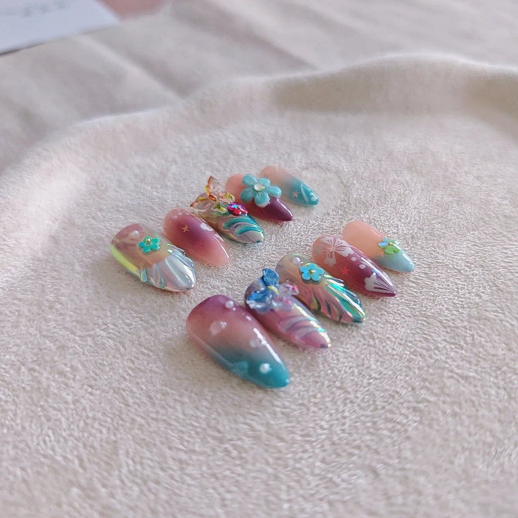 Handmade press-on false nails with embossed colourful small flowers and butterfly designs in almond shape.