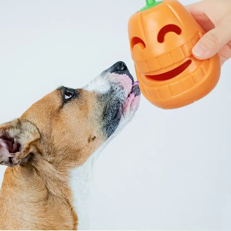 Yellow pumpkin-shaped TPR dog chew toy for aggressive chewers on a white background.