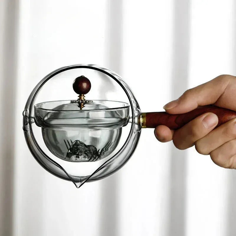 Rotating glass teapot with wooden handle and stainless steel infuser basket