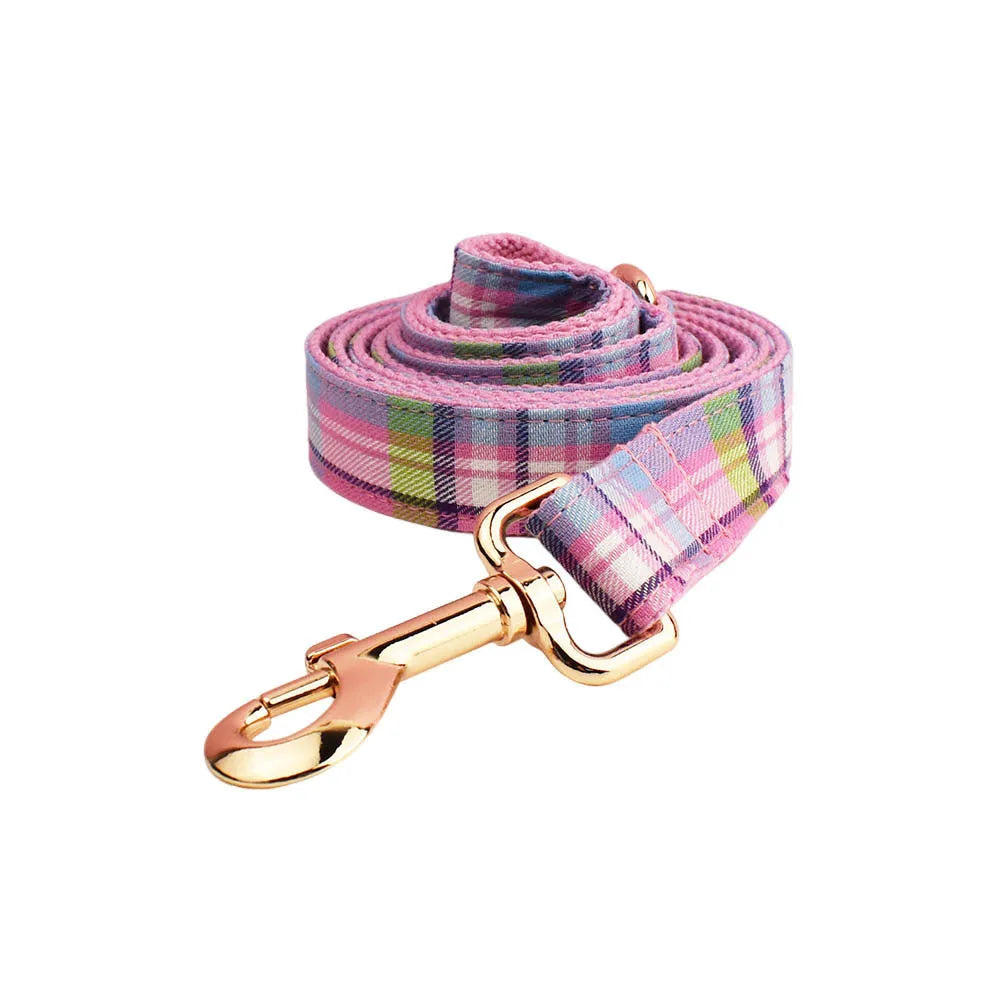 Four-piece dog accessory set with collar, leash, vest and decorative bow in cloth construction