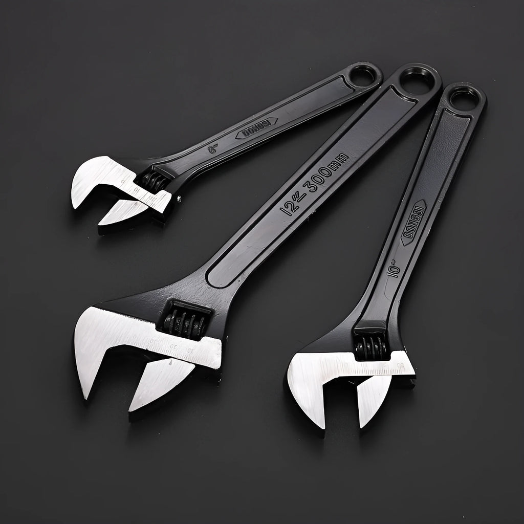 High carbon steel adjustable open-end wrench with black finish on a workbench.