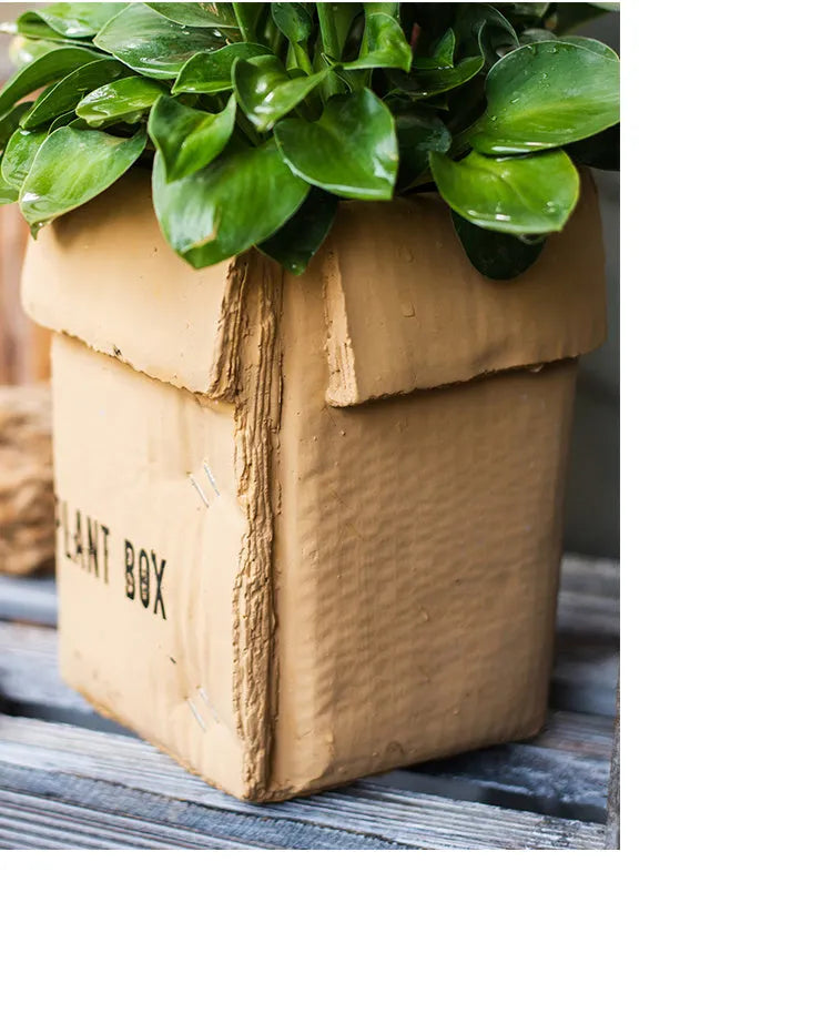 Cement brown paper box style flowerpot with bottom drainage holes for indoor plants