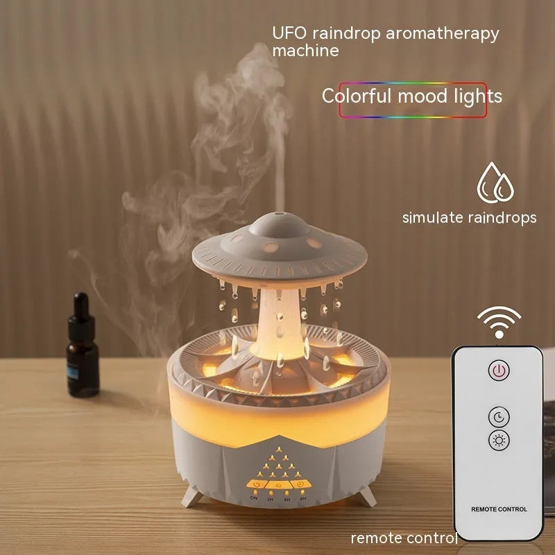 White cloud-shaped humidifier with raindrop mist and coloured night light on wooden table