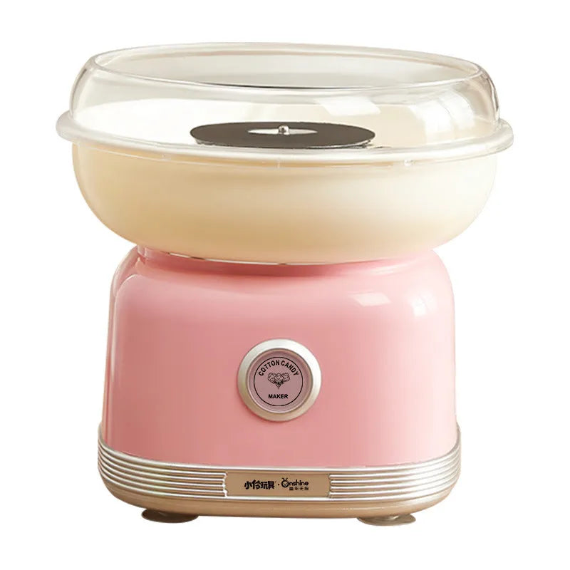 Pink mini electric cotton candy making machine with stainless steel body on a kitchen counter