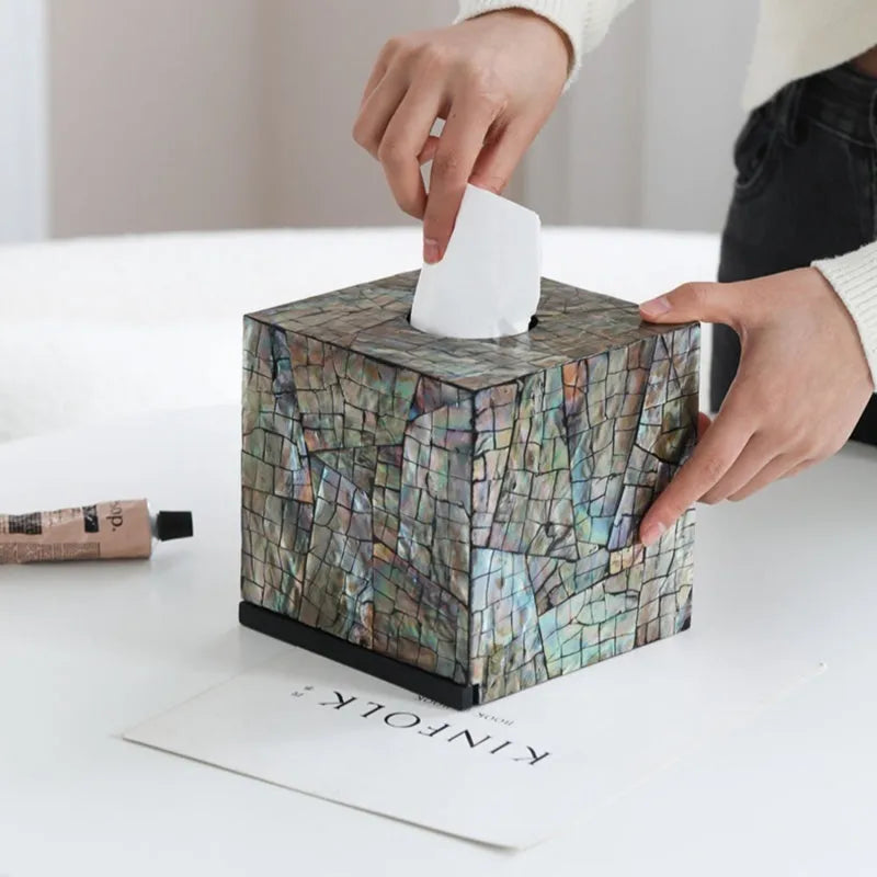Natural shell decorative storage box tissue holder in square and rectangular shapes on a table.