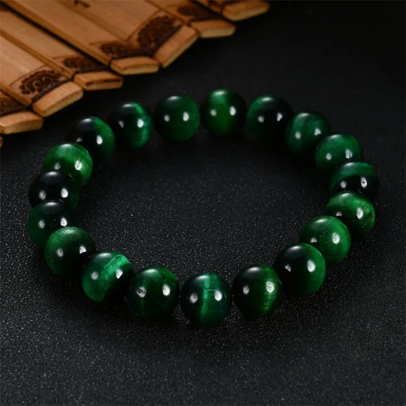 Natural green tiger eye stone bracelet with polished geometric beads in multiple sizes