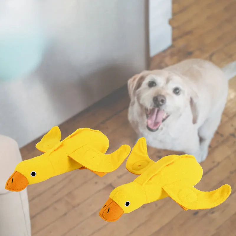 Yellow plush teddy bear dog toy with an attached duck doll, featuring a squeaker and treat compartment.