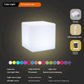 White square LED cube stool light on patio, modern outdoor seating with integrated lighting.