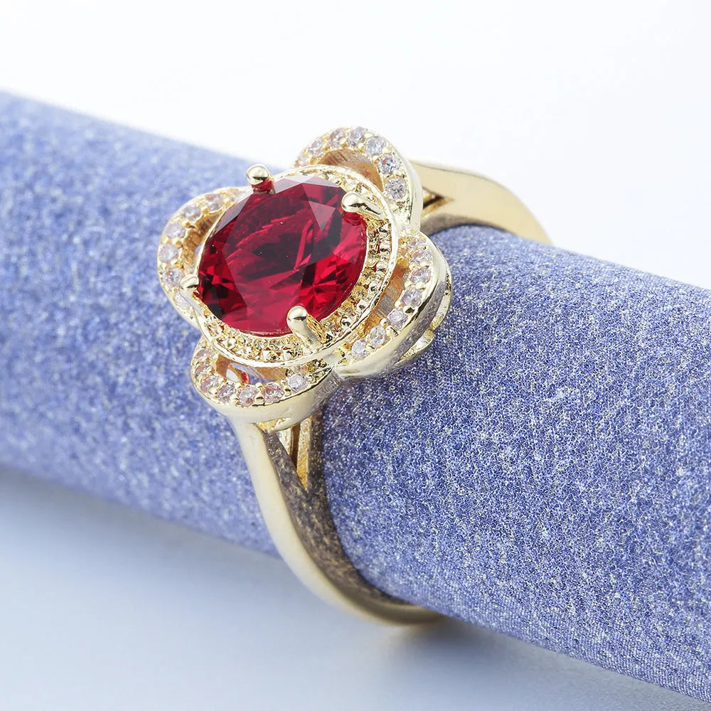 Copper fruit-shaped ring with a zircon stone, showing electroplated finish.