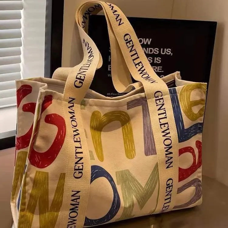 Large canvas tote bag with printed design options for travel and shopping