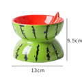 Ceramic raised cat bowl with tilted design in orange pattern, showing elevated feeding station for pets