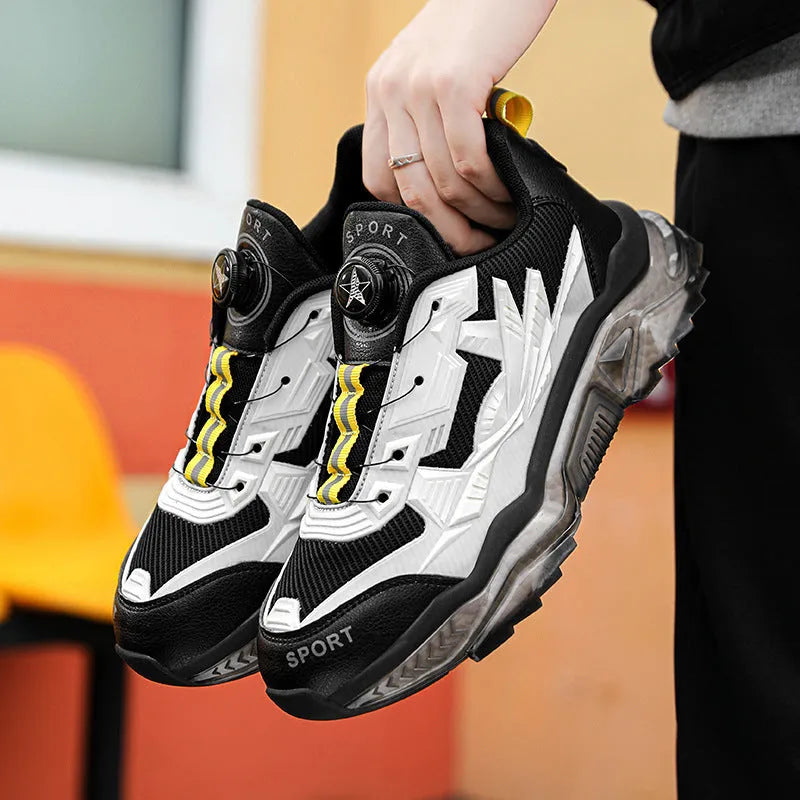 Men's black mesh casual shoe with rotating button fastener and platform sole.