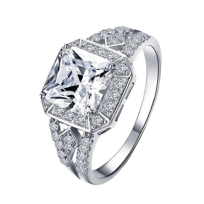 Geometric hollow zircon ring for women in platinum colour on copper, showing quadrilateral design and inlaid stones.