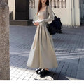 Women's black square collar knitted dress with long sleeves, elastic waist, and A-line long skirt.