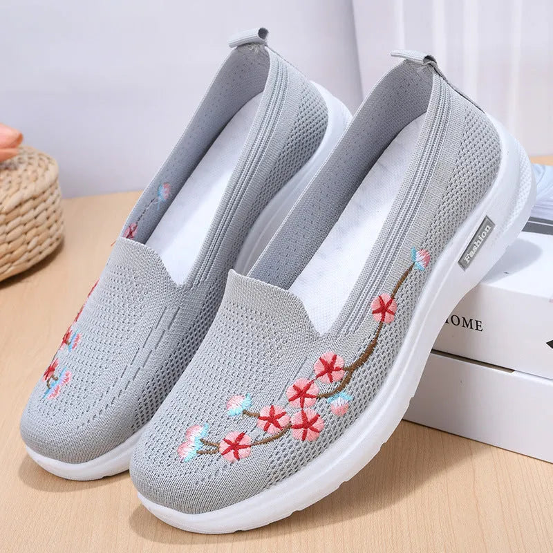 Women's wine red embroidered floral sports pumps with a flat heel and anti-slip sole on a white background.