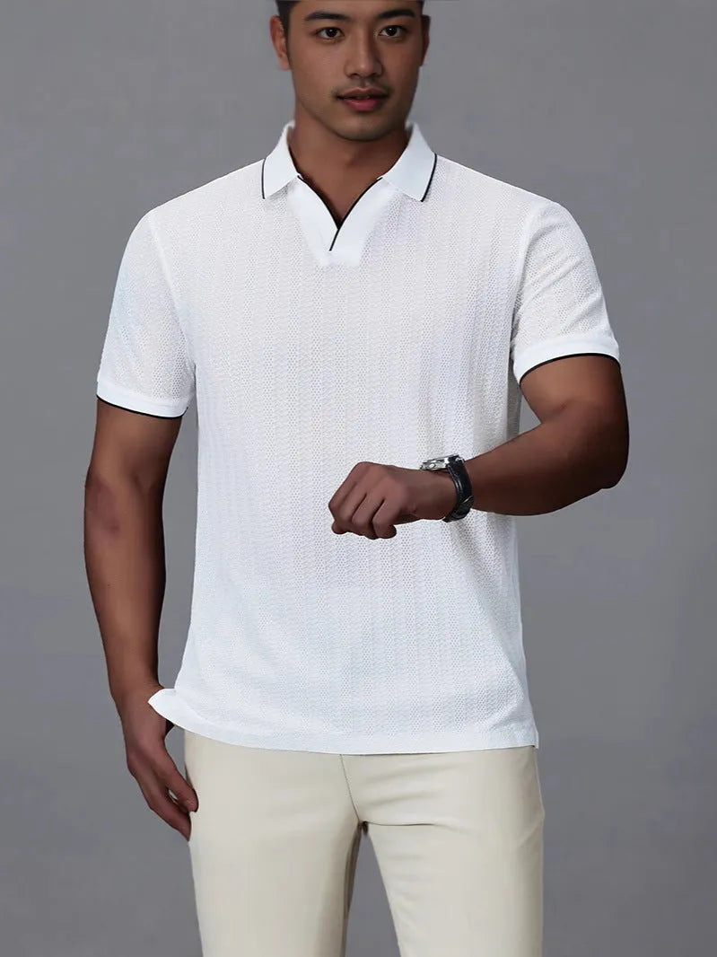 Man wearing a loose-fit black nylon polo shirt, short sleeves, casual style.
