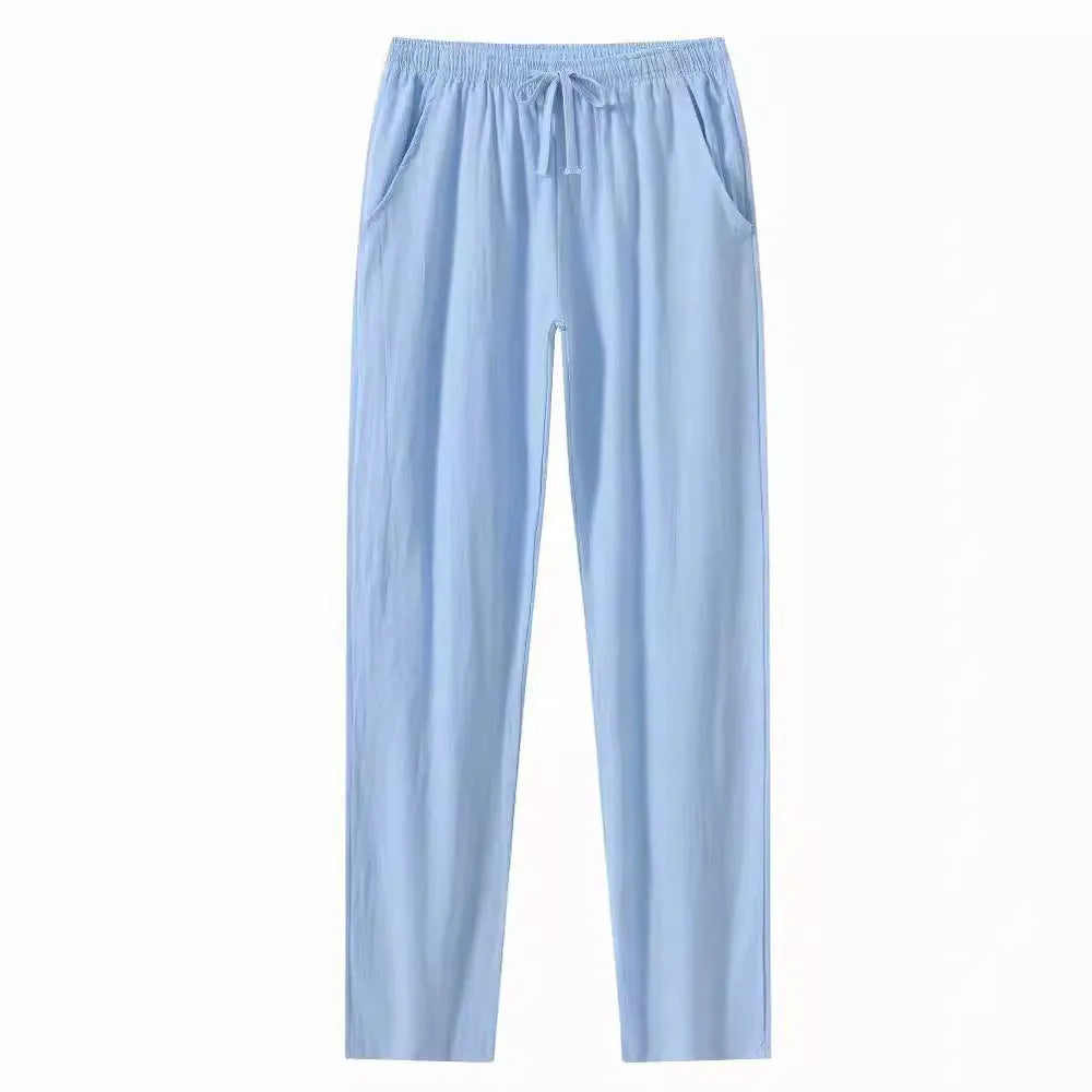 Men's loose-fitting cotton beach pants in khaki colour on a casual background.