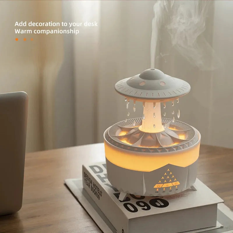 White cloud-shaped humidifier with raindrop mist and coloured night light on wooden table