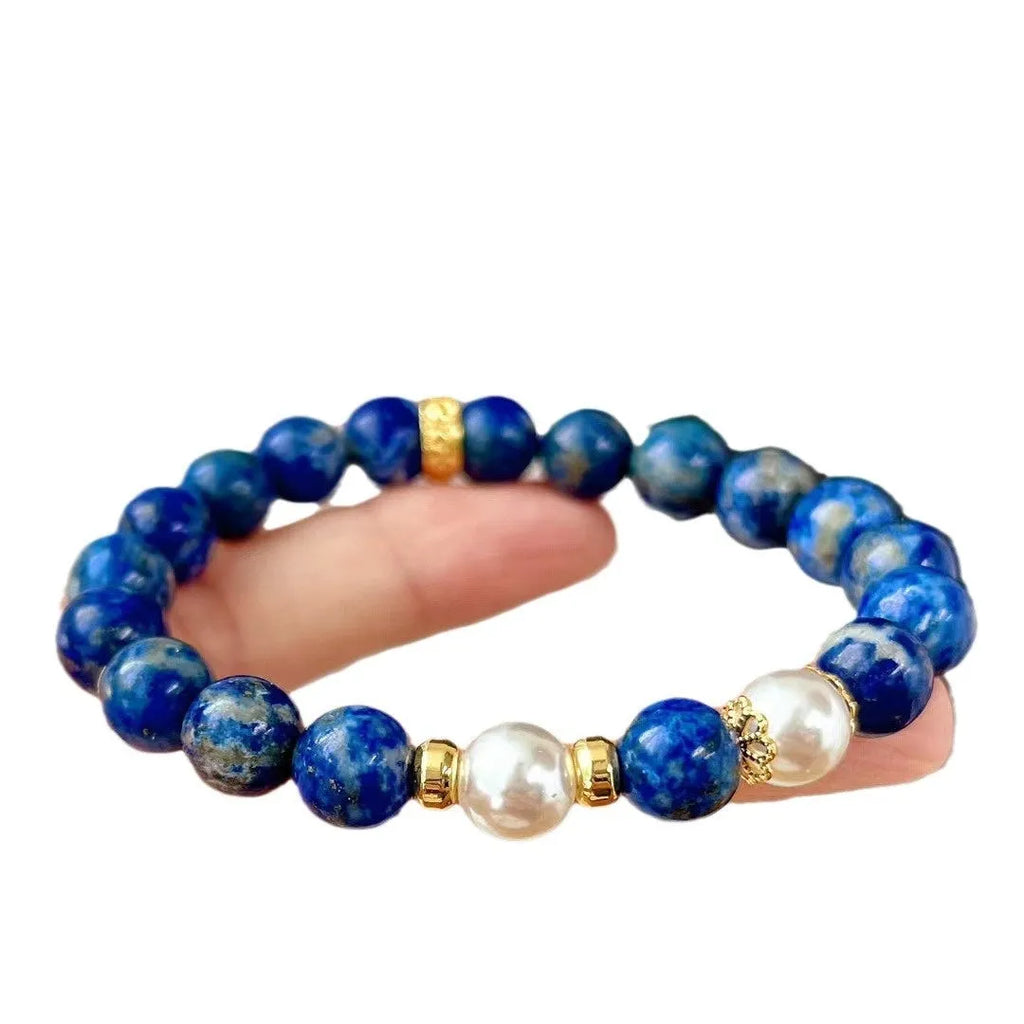 Natural green and gold lapis lazuli stone bracelet with a Chinese retro design on a wrist.
