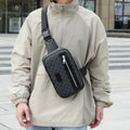 Men's black crossbody bag with chest strap and decorative sewing lines