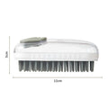 Grey silicone pet bath brush with flexible bristles and non-slip handle for washing dogs and cats.